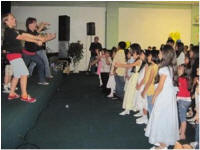 children watching performance on stage